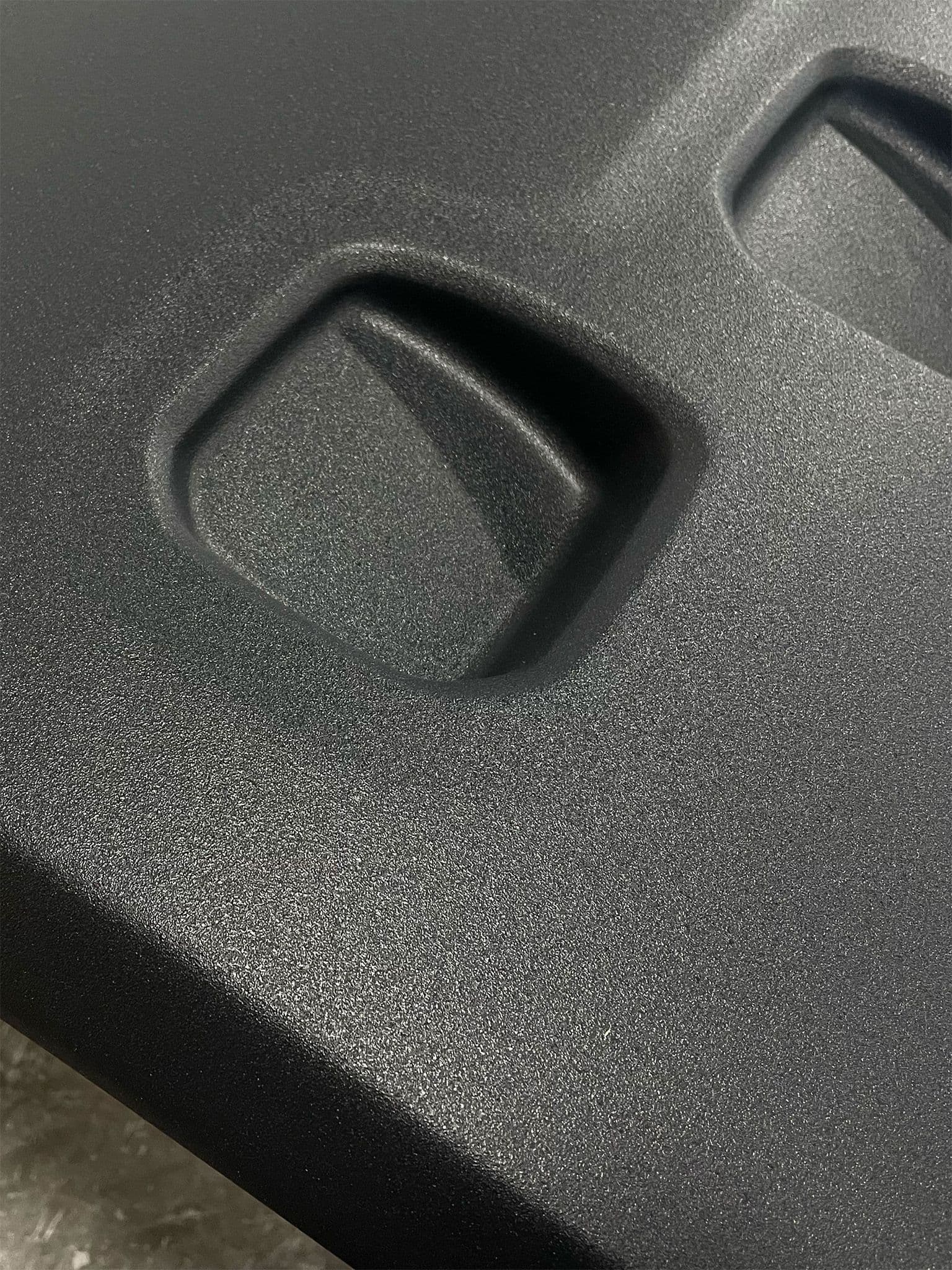 Another angle of the Escapod trailer’s fiberglass surface, showcasing the molded design details and durable matte finish.